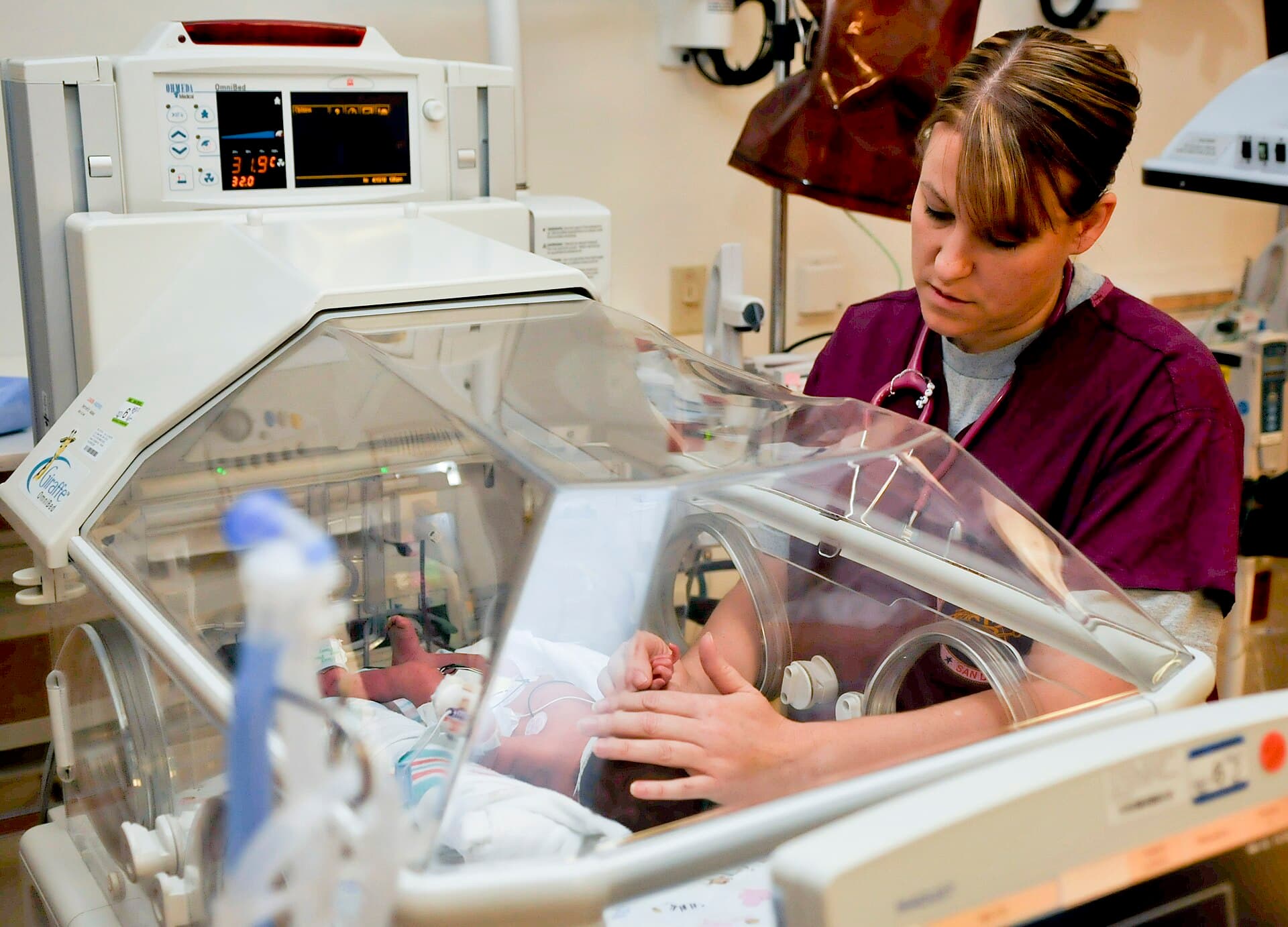 A U.S. Navy nurse checking a newborn in a San Diego hospital nursery
