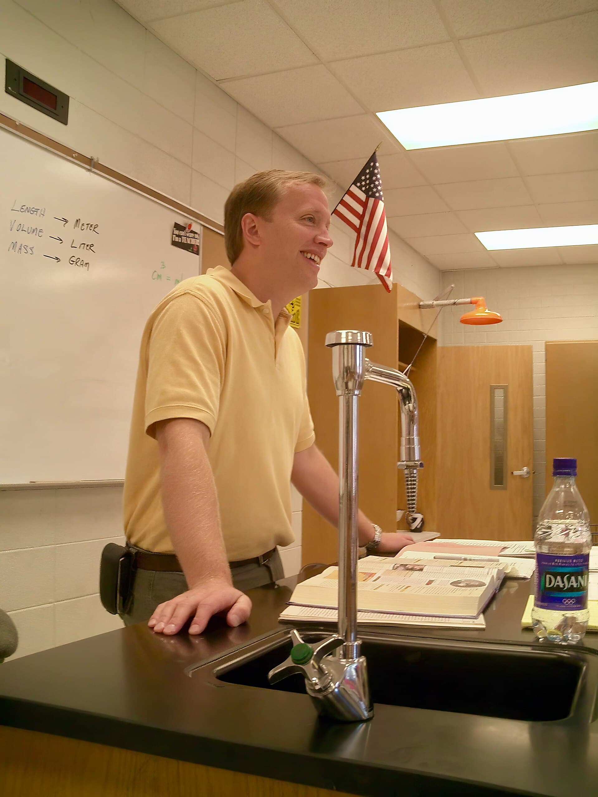 A public high school teacher standing in a classroom in the United States