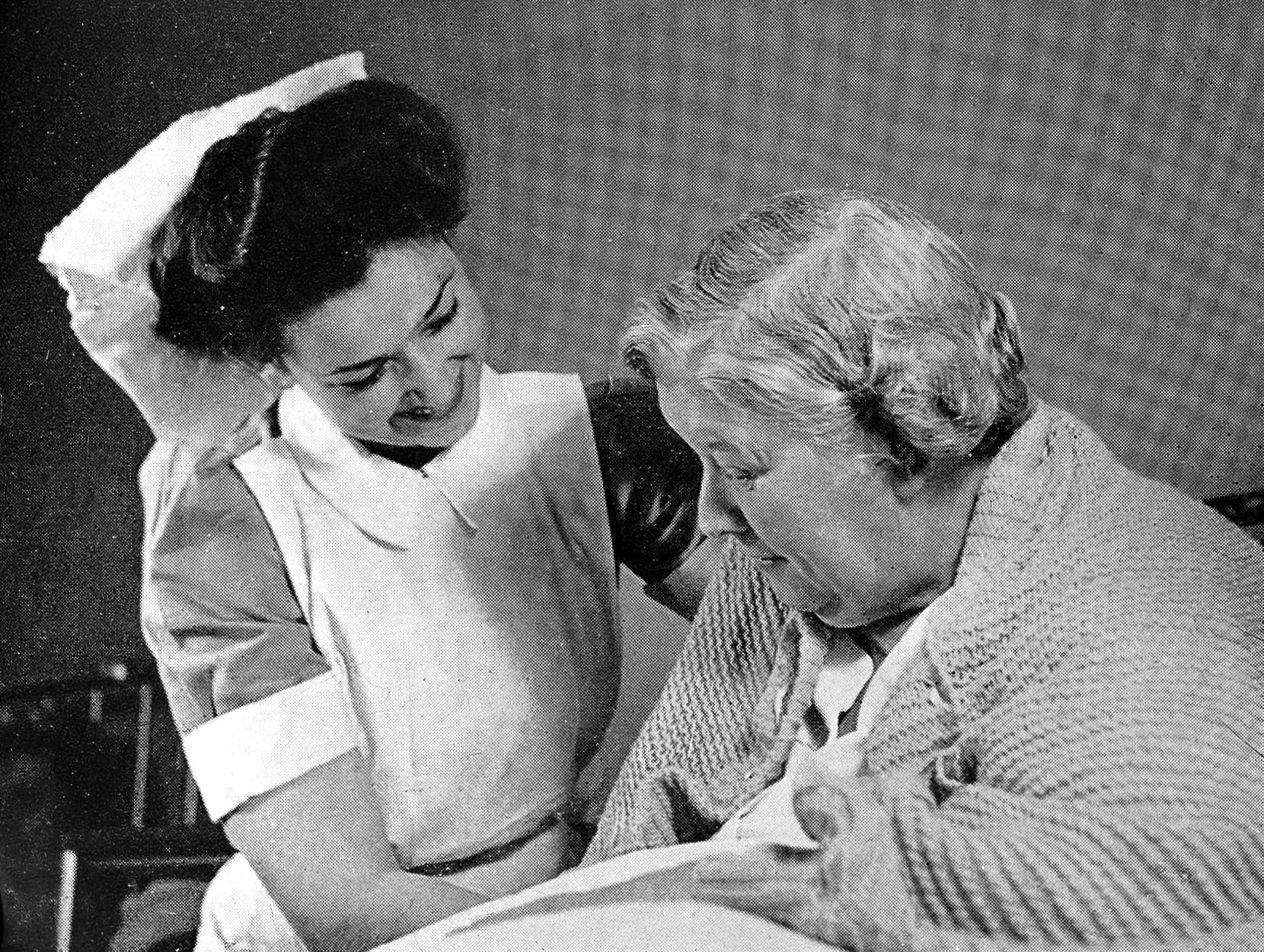 A nurse attending an elderly patient in a hospital