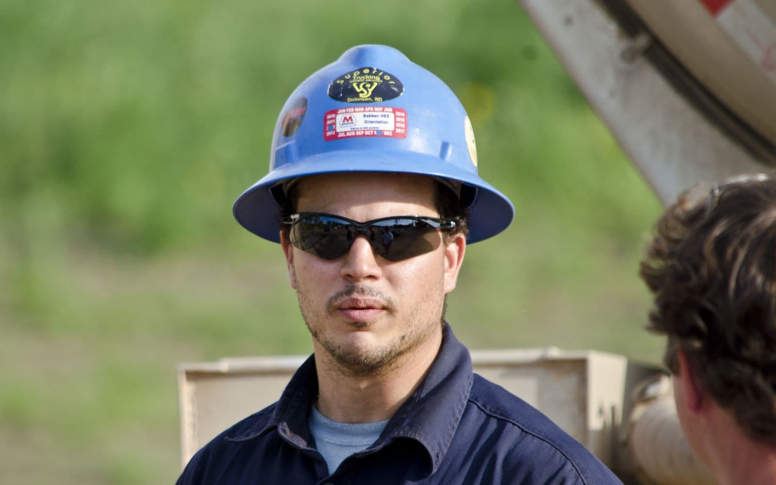 An oil truck driver in the cab of a truck at a well site near Arnegard, North Dakota
