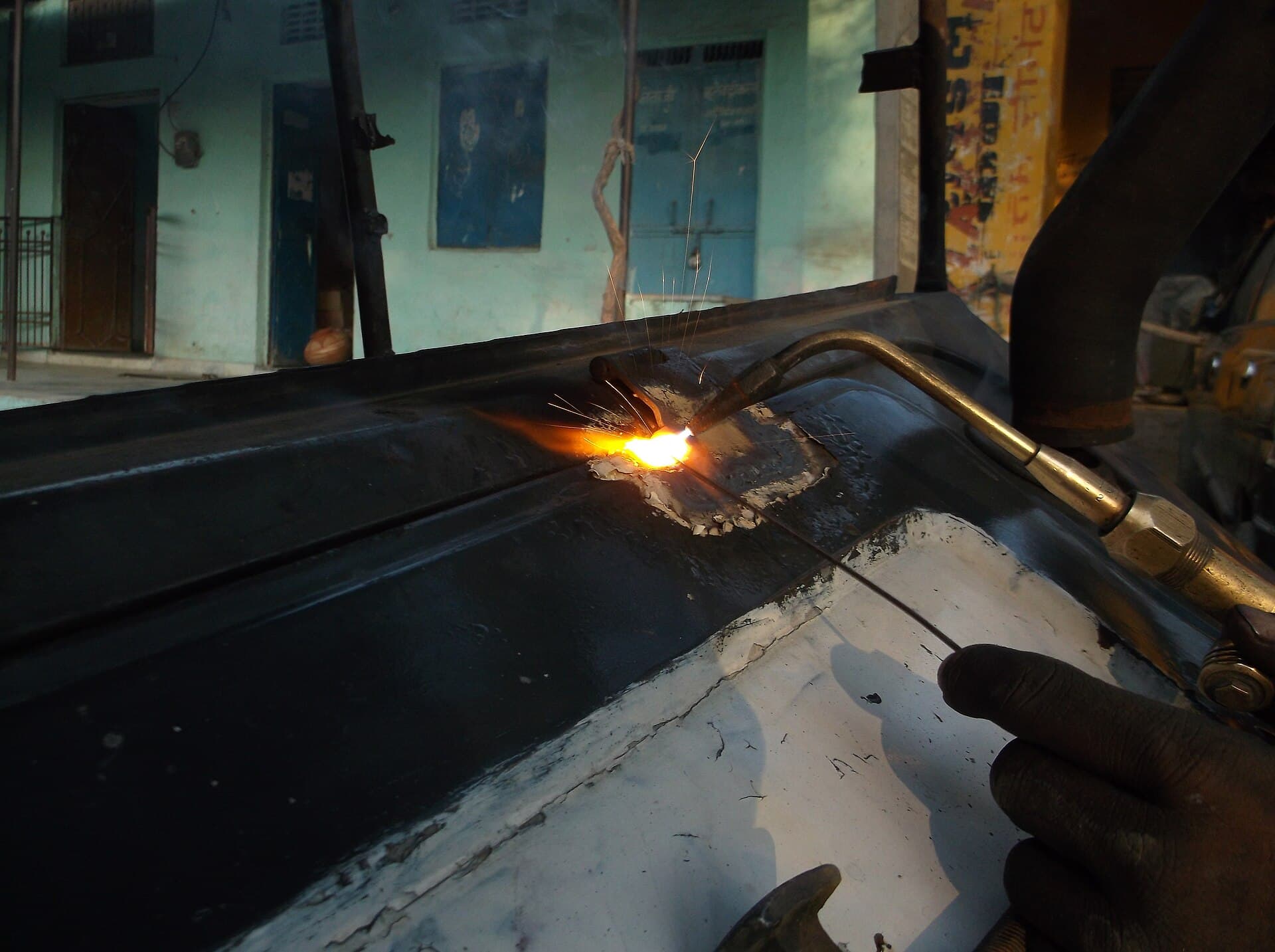 A welder at work with a torch